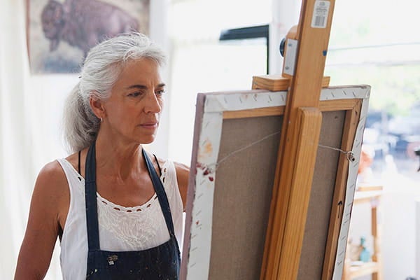Woman painting a picture.