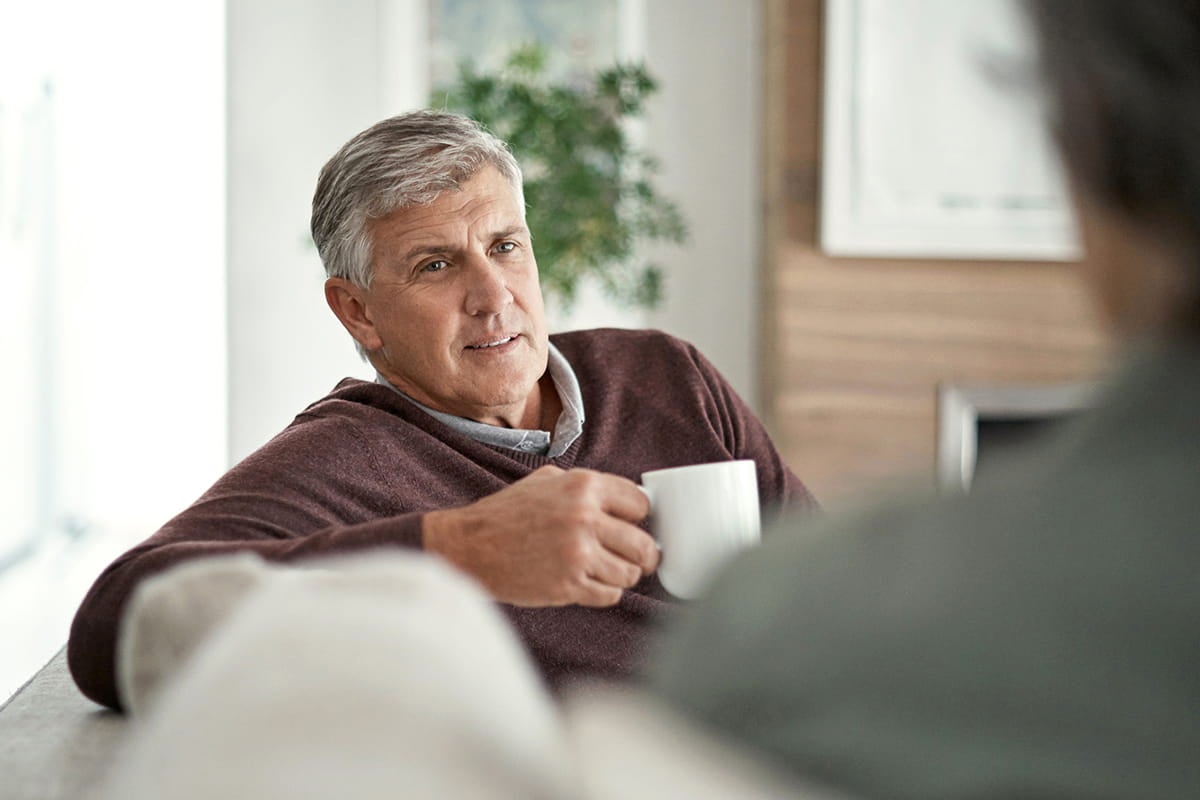 Man having coffee; specialists at Ascension St. Vincent’s Cancer Care deliver advanced care for brain and spine cancer.