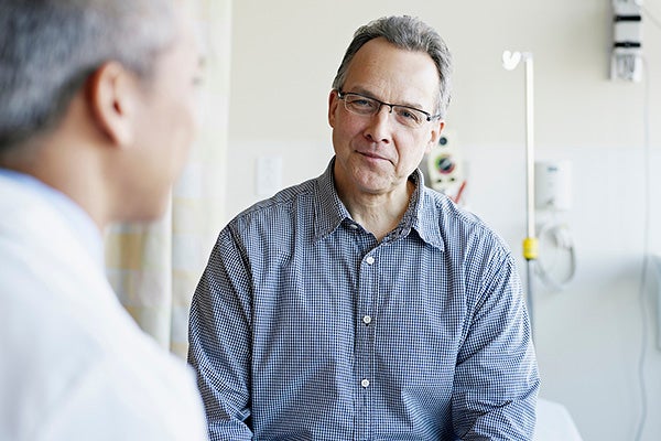 Man talking with a surgeon.