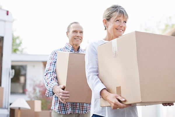 Man and woman carrying boxes.