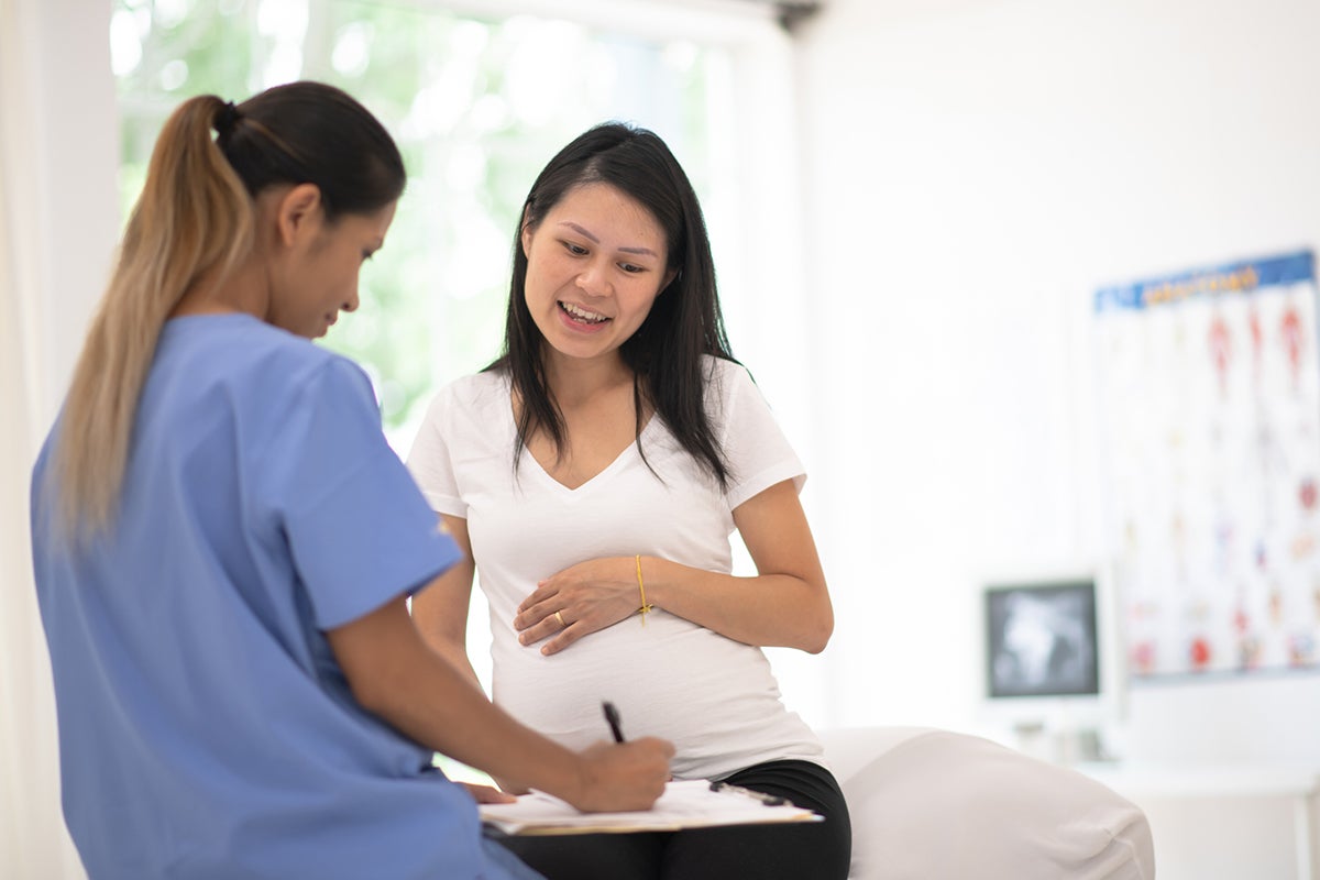 Woman with a high-risk pregnancy meeting with a maternal-fetal medicine specialist at Ascension Seton in Austin, Texas.