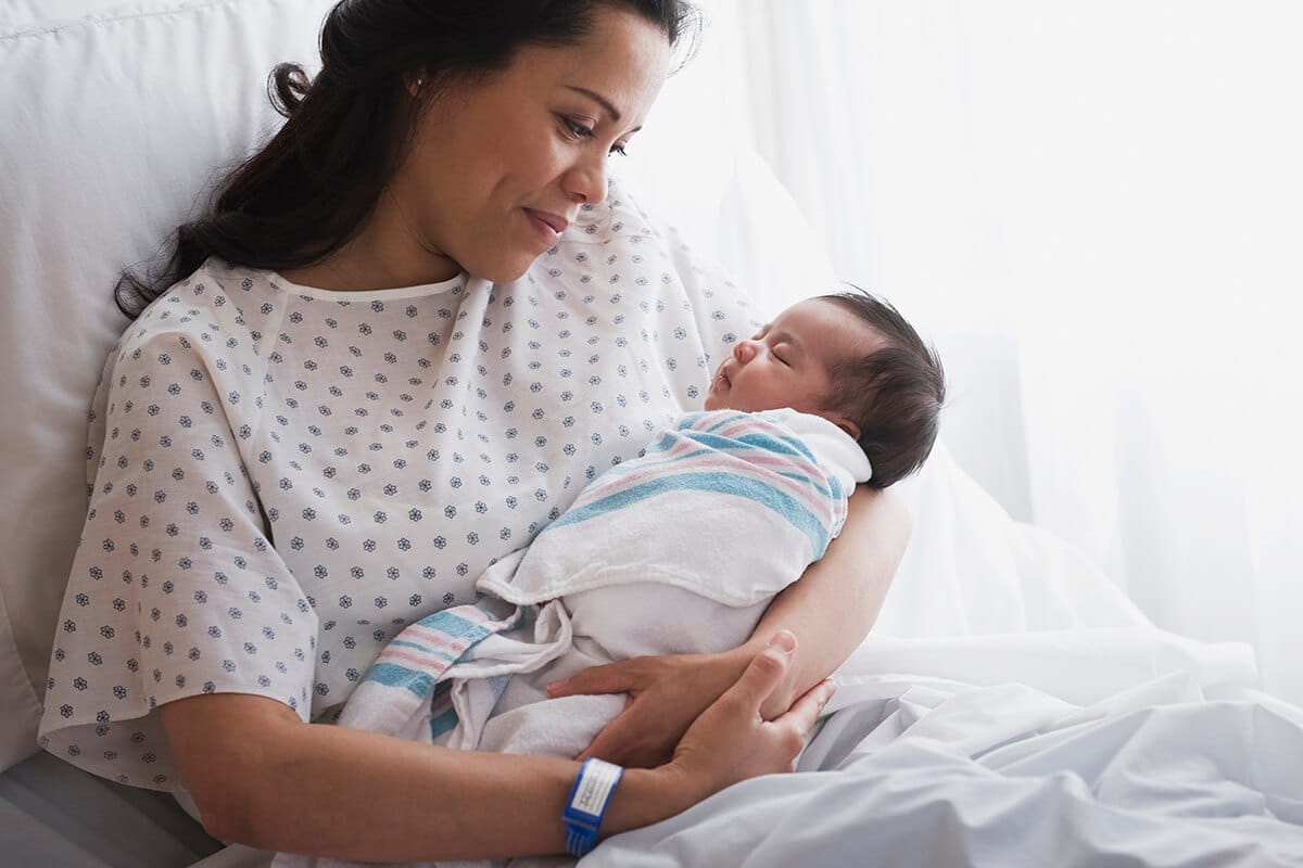 New mom holding her baby at a birthing center