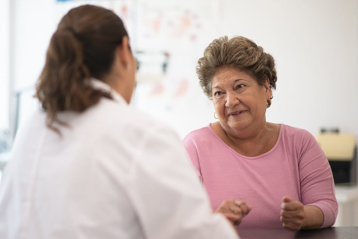 Woman with nurse; thoracic lung specialists at Ascension St. Vincent's Cancer Care deliver advanced care and support.