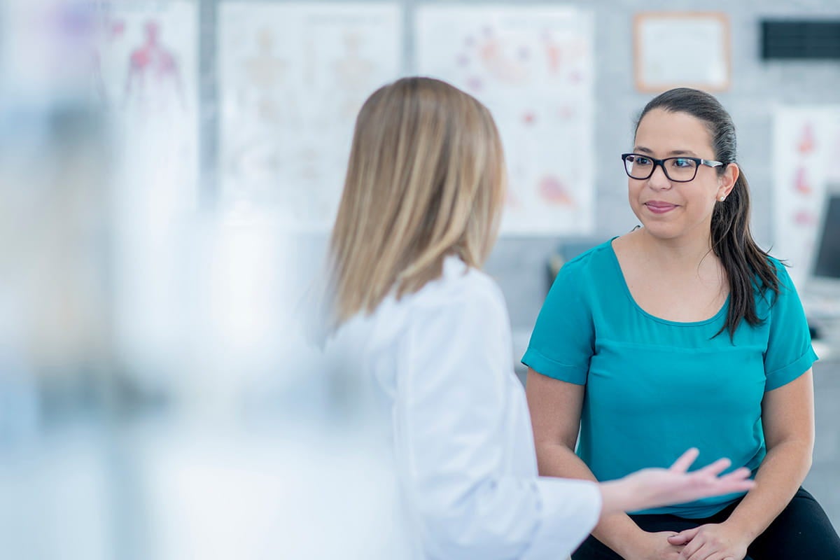 Woman talking to a primary care doctor.