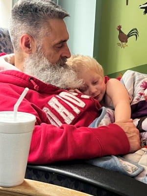 father holding daughter.
