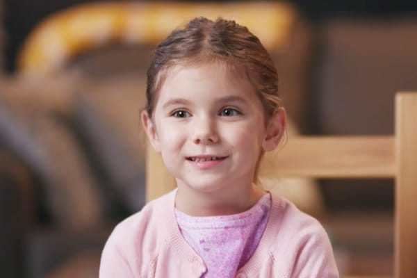 Girl sitting in chair smiling 