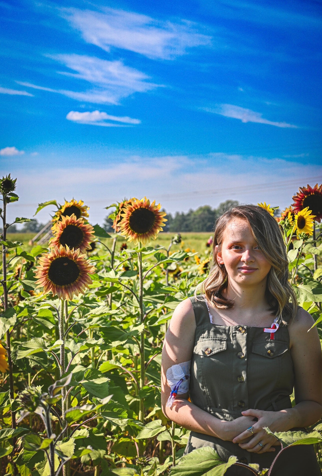 Girl standing in a sunflower field