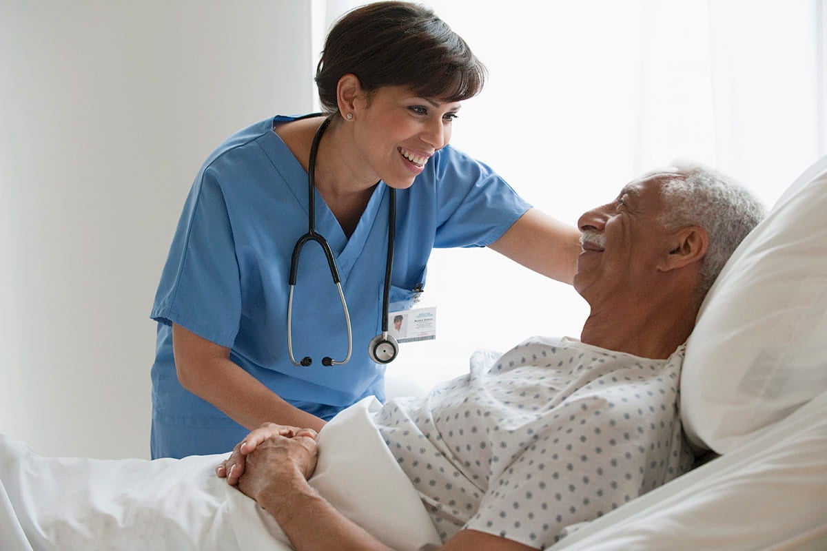 Man lying in a hospital bed.