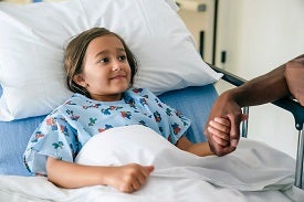 Girl in hospital bed.