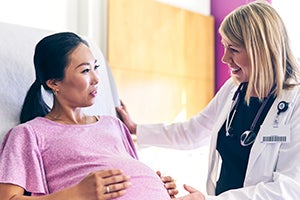 Pregnant woman talking to her doctor.