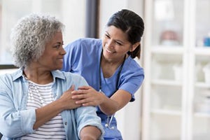Woman speaking with a nurse.