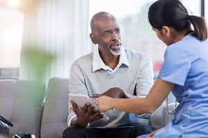 Man speaking with a nurse.