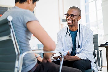 Male doctor talking with a male patient.