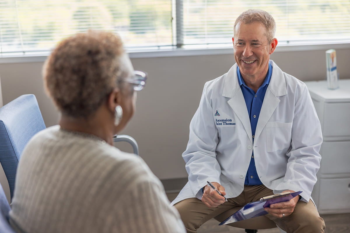 Dr. Douglas J. MacKenzie, a plastic surgeon at Ascension Saint Thomas in Murfressboro, TN, speaks to a patient