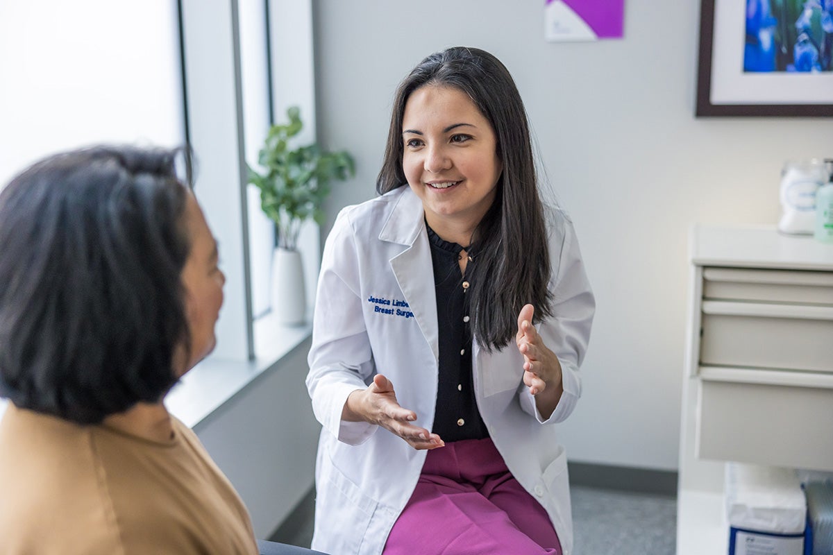 Jessica Limberg, MD talking with a female patient.