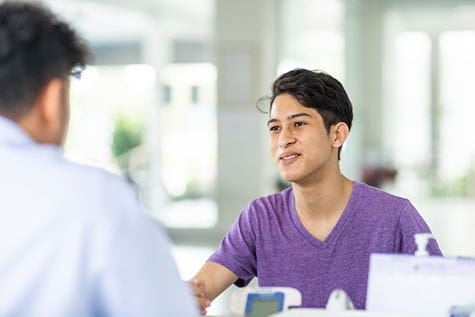A teen talking to a family medicine doctor.
