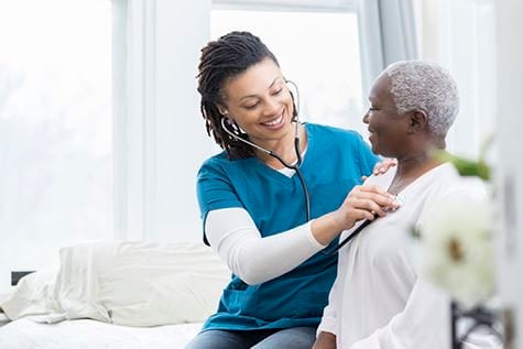 A woman being examined by a nurse.